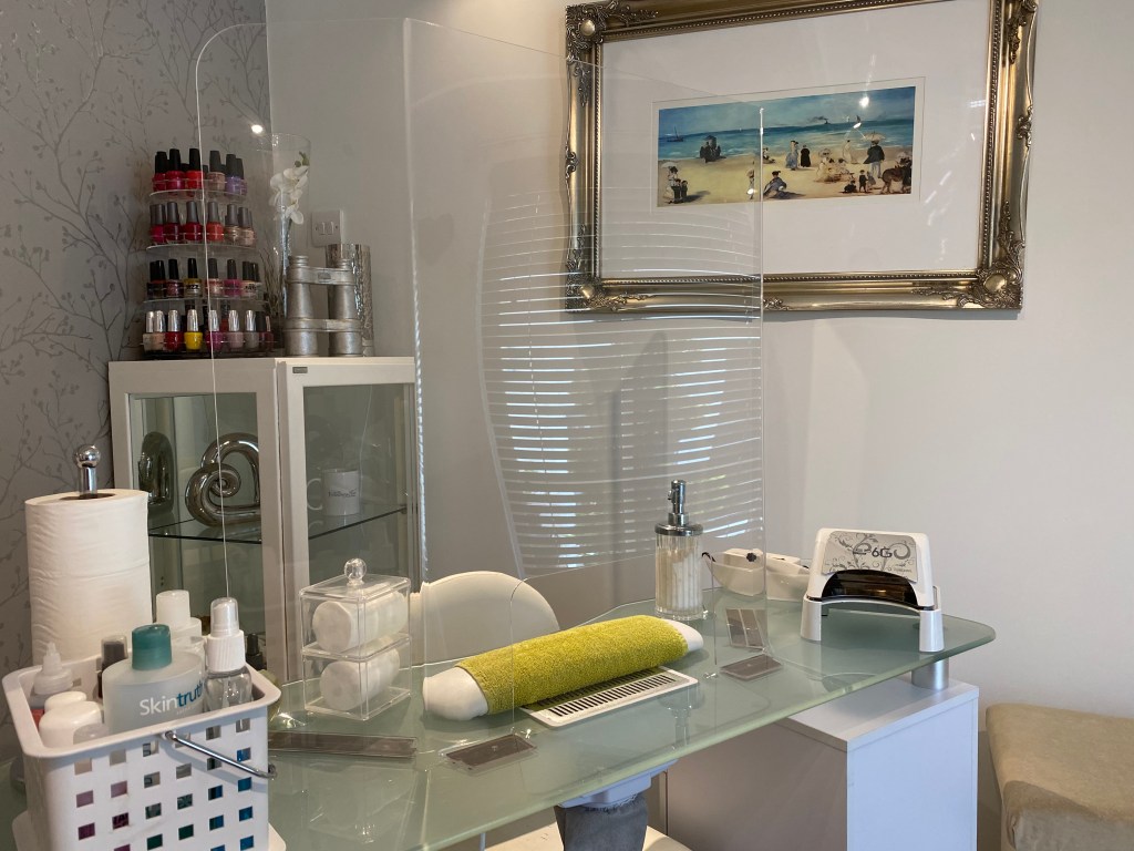 Perspex shield installed at the nail station.